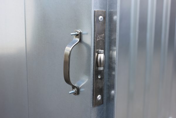 Stainless steel handle on a grey, refurbished storage unit